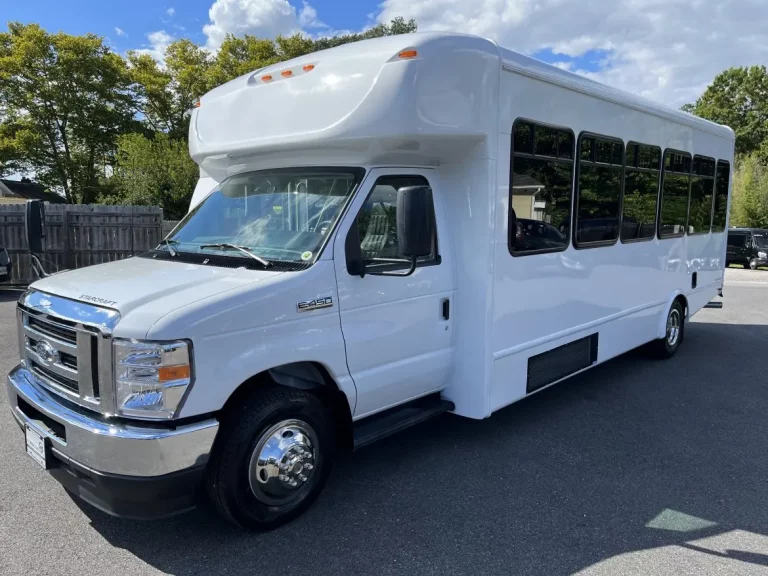 a white 32 passenger mini bus