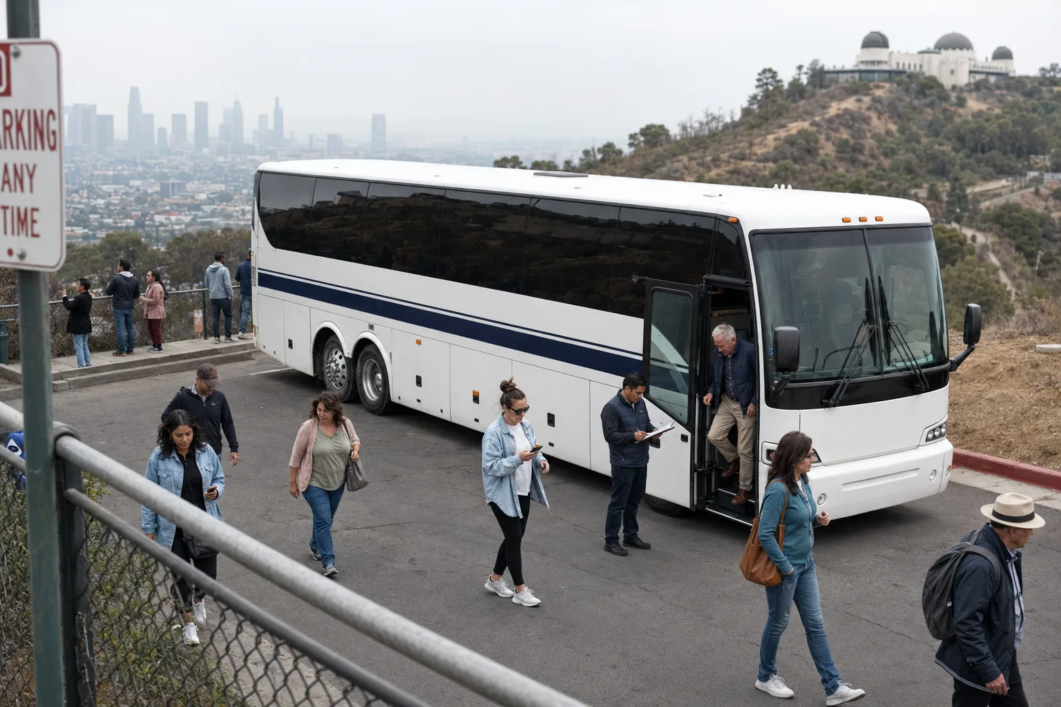 Tour group disembarking a charter bus at a Griffith Observatory overlook in Los Angeles